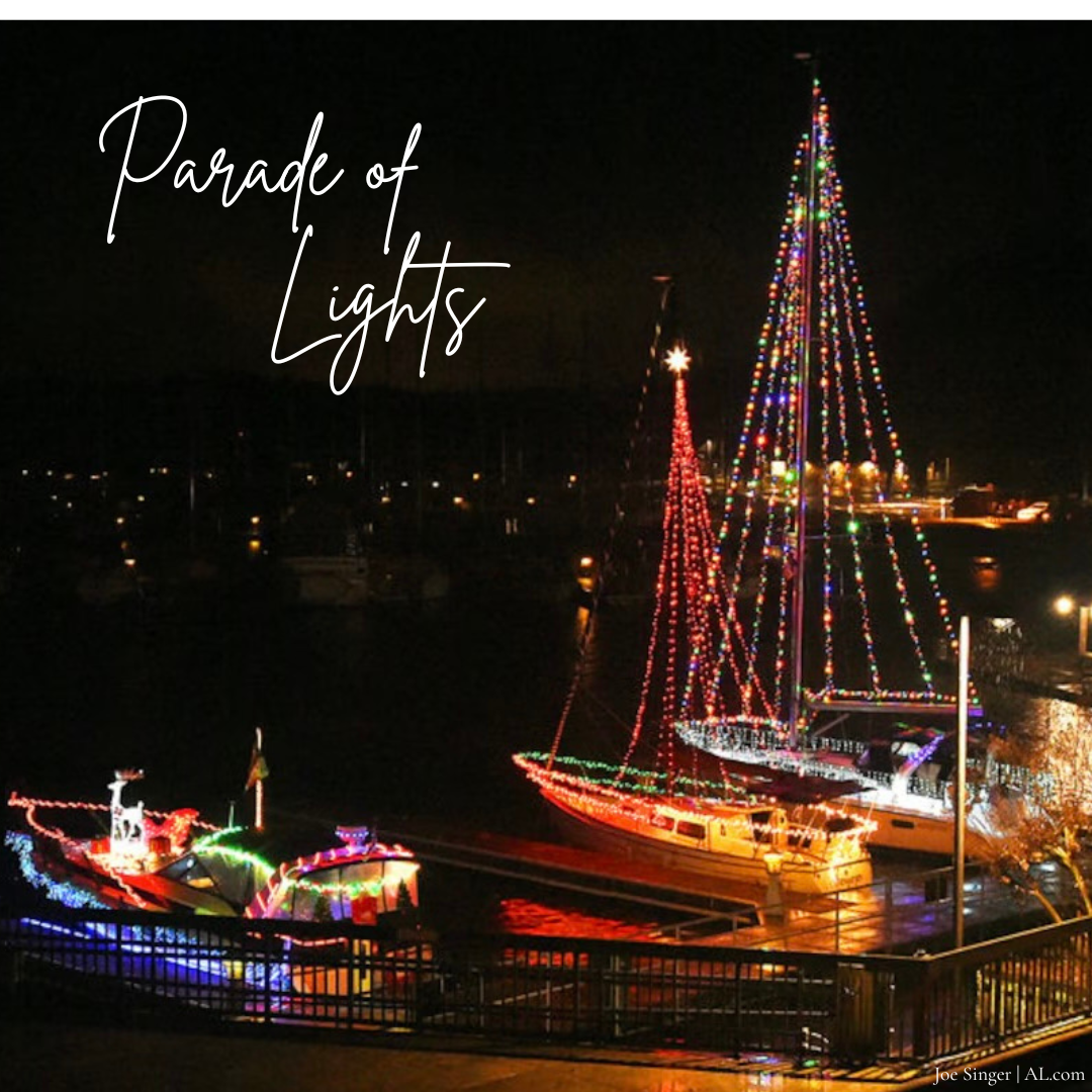 Picture of boats decorated in lights on Lake Wheeler.