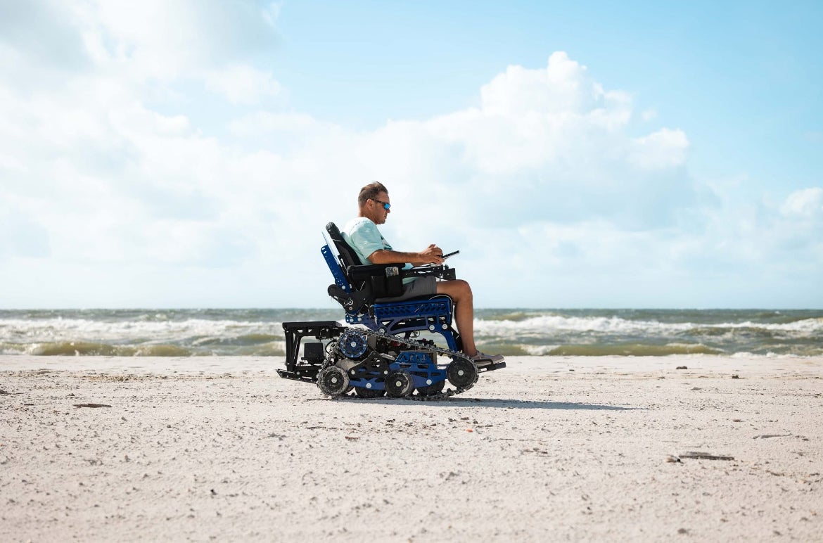 Picture of a man using an Action Trackchair on the beach.